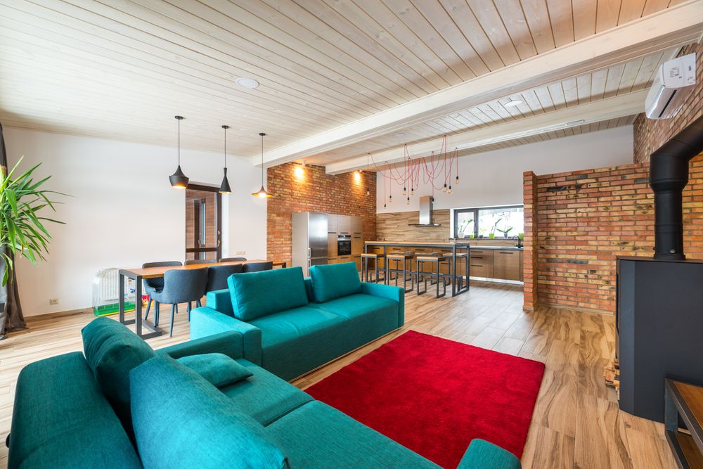 Loft living room with teal sofas (stock photo)