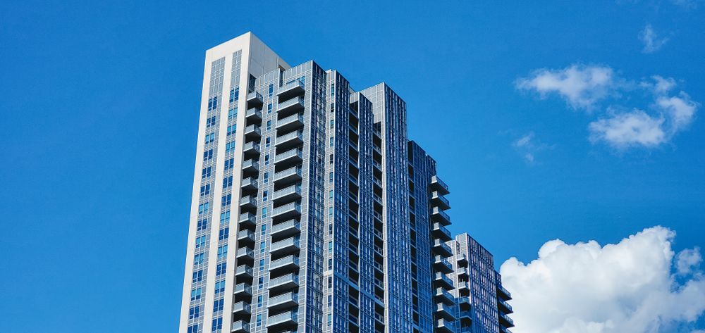 Stock photo: tall residential tower against a blue sky